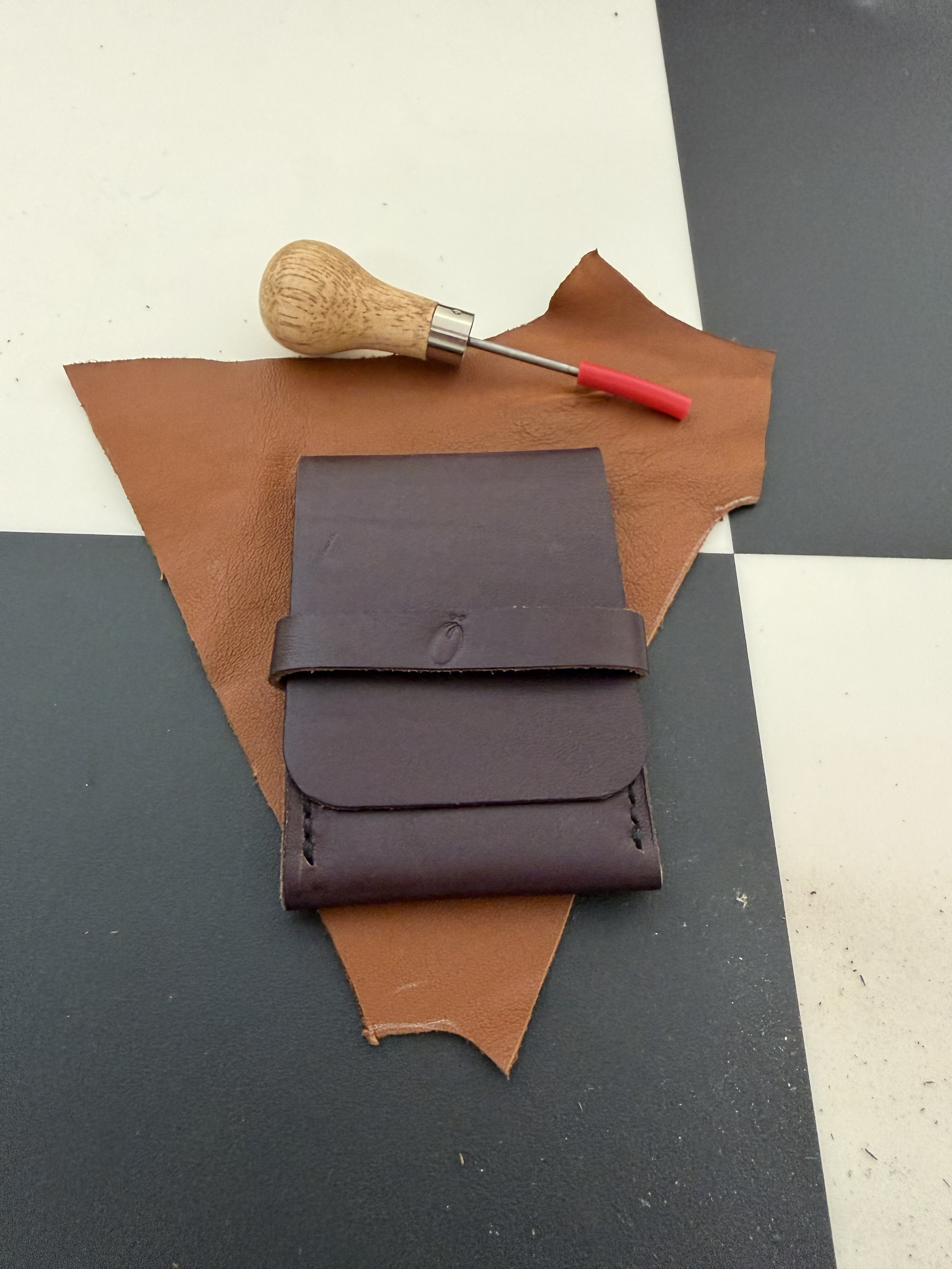 Small brown snap-closure leather pouch