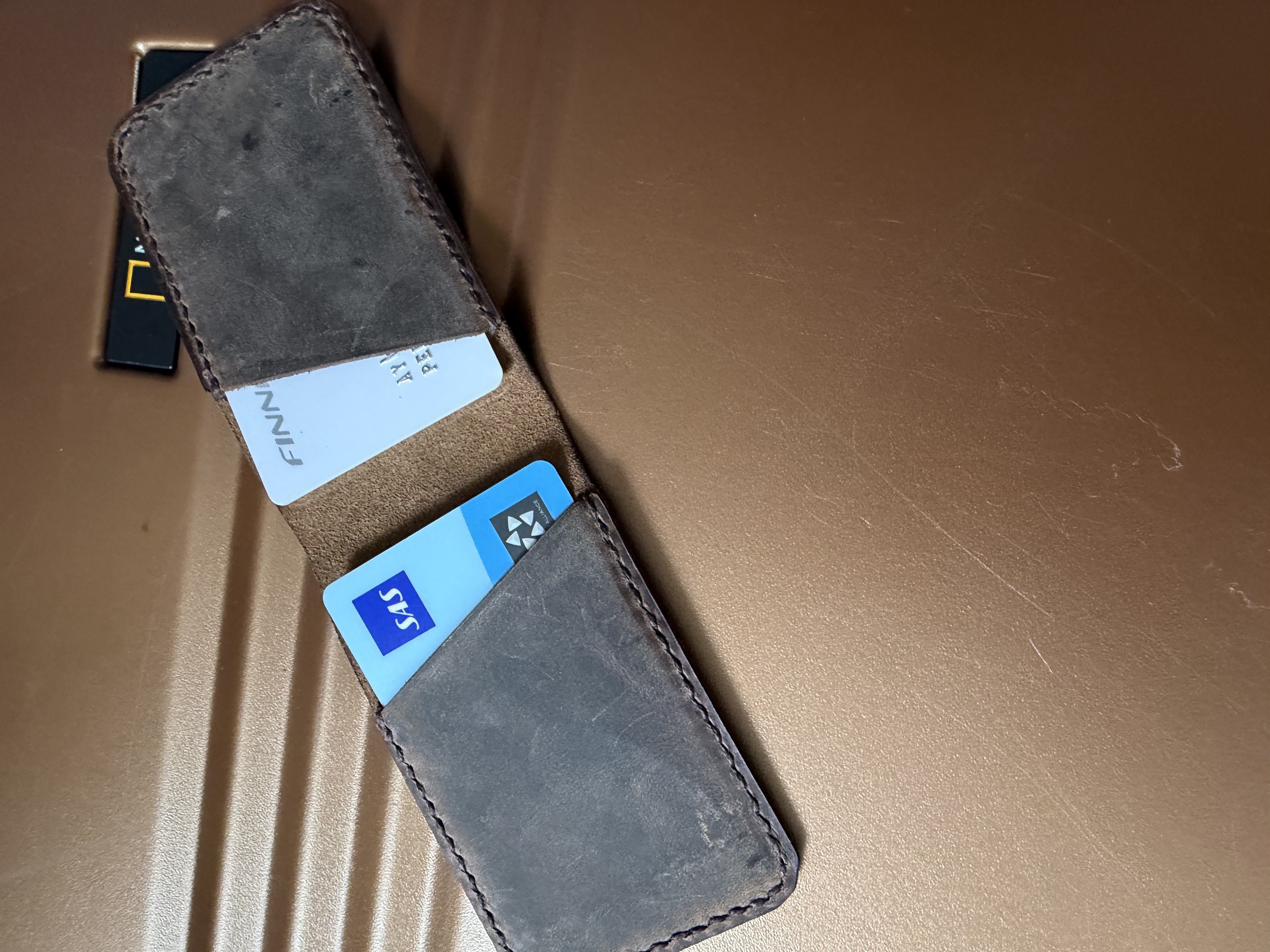 Open folding wallet showing card slots with cards inside