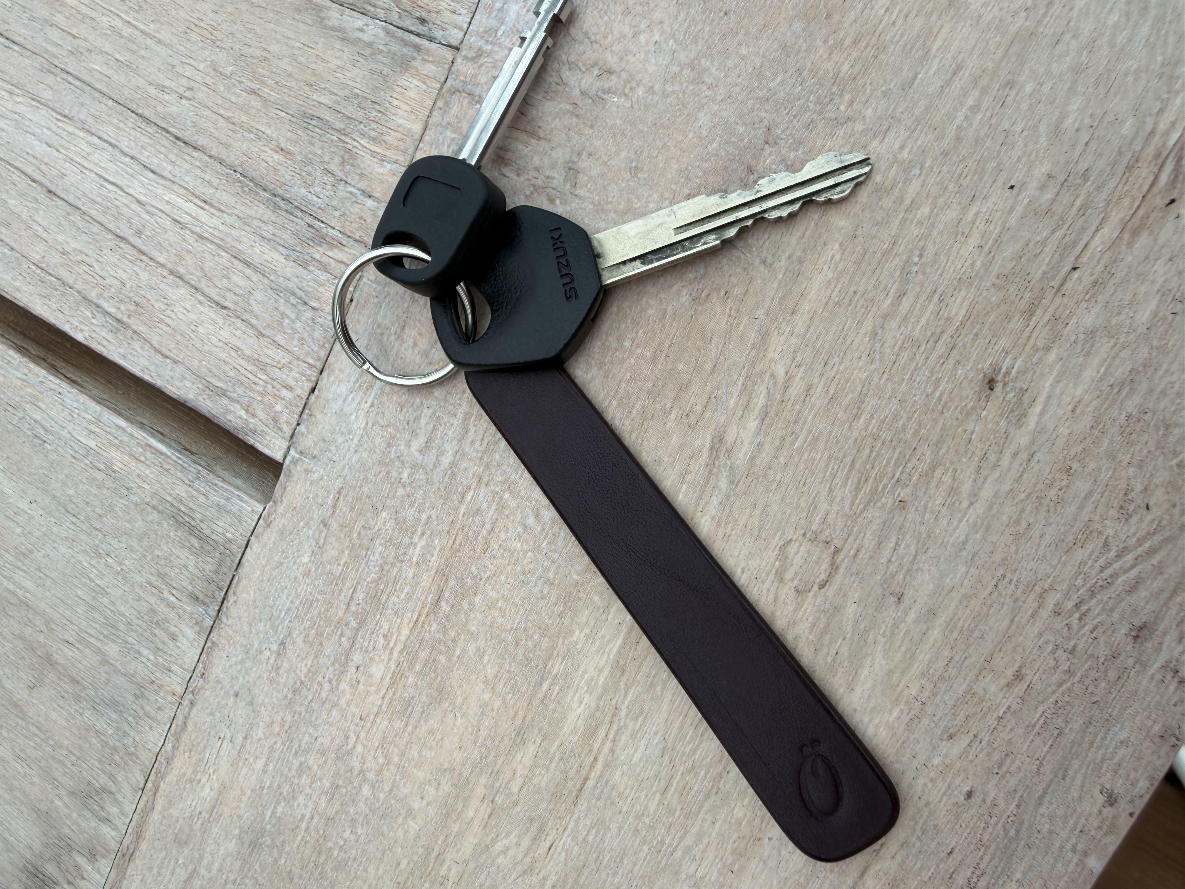 Full-grain leather keytag with maker's mark, attached to a set of keys