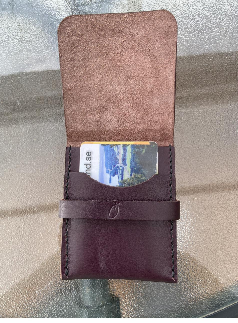 Open wallet with a bank card tucked into the front slot