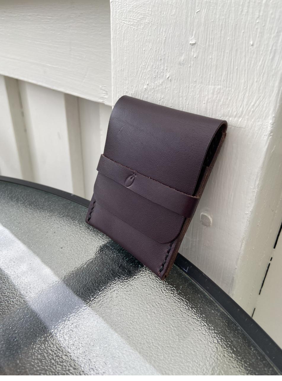 Fold-over wallet with wraparound strap, outdoor setting